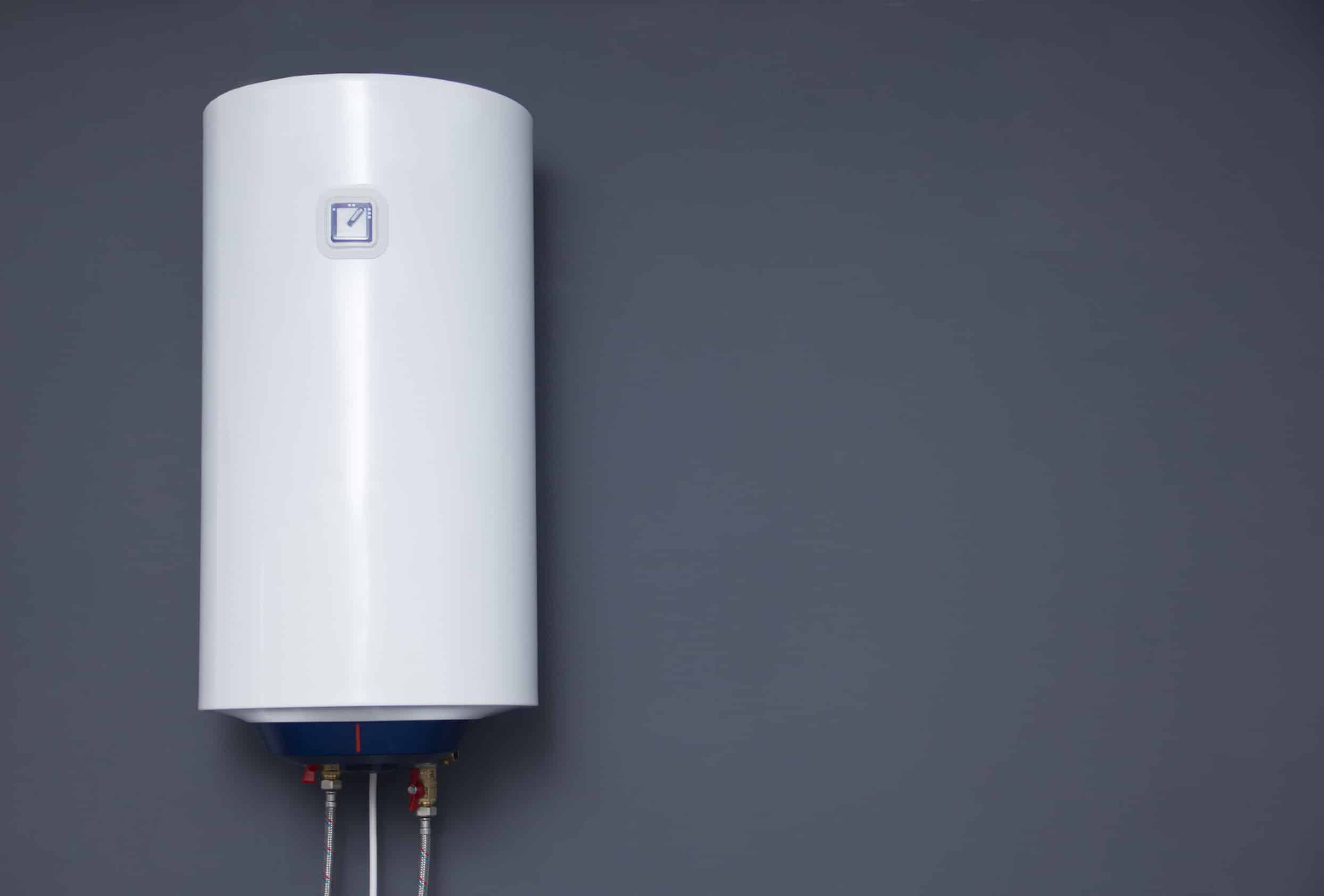 modern electric boiler on a gray plain wall. white water heater. space for text